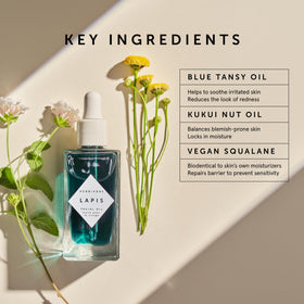 HERBIVORE Lapis Facial Oil bottle in use with gentle facial massage.