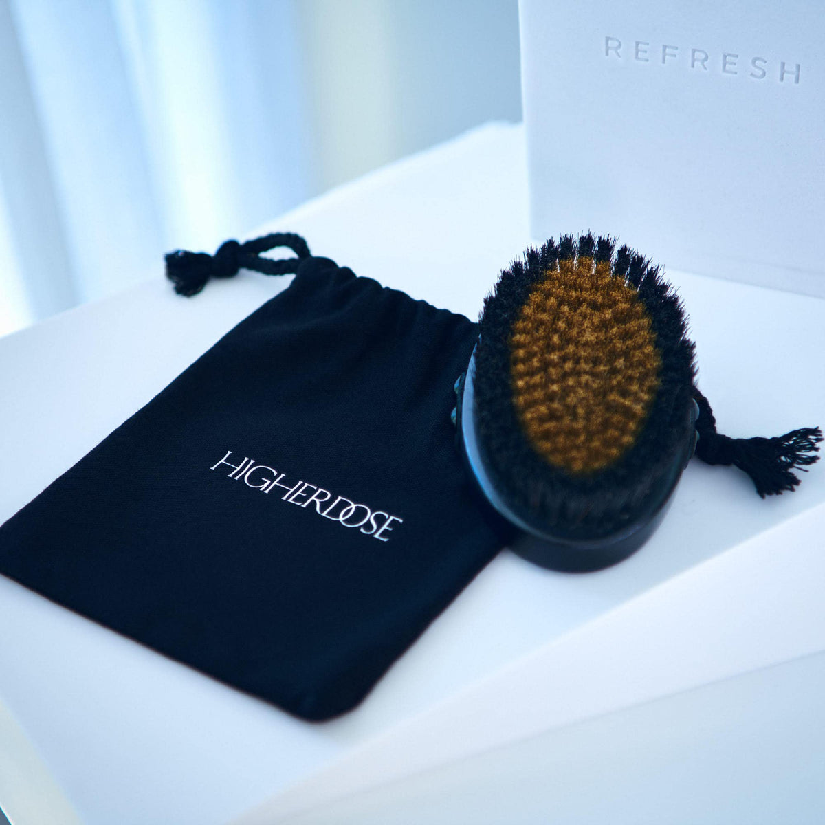 HigherDOSE Ritual with dry brushing tool as part of daily self-care.