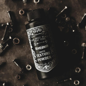 The Holy Black Matte Texture Powder on-the-go compact for quick styling.