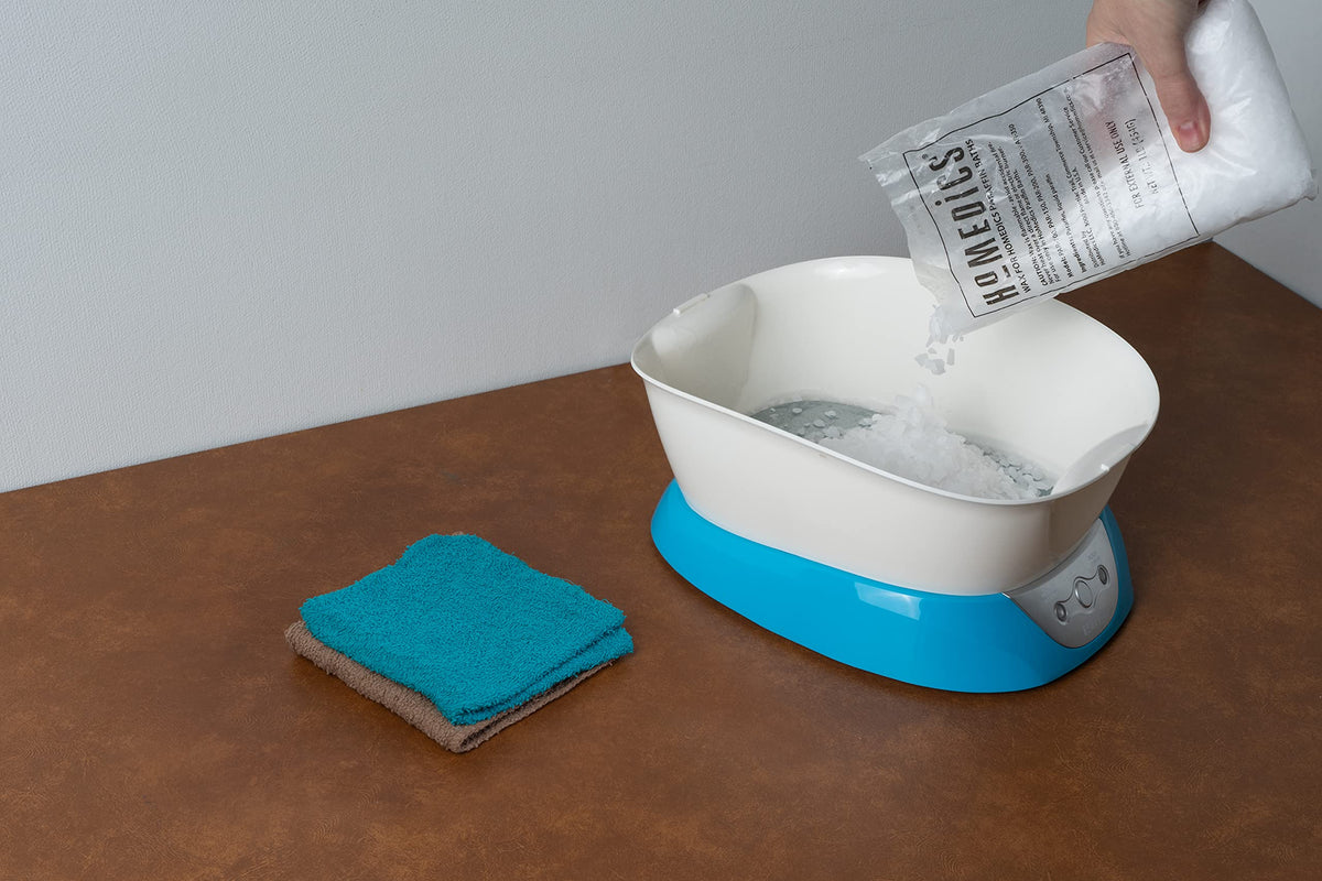 Hands using HoMedics paraffin bath with refill for smoother skin