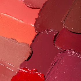 Close-up texture of Honeybee Gardens lipstick showing rich pigment and soft feel.