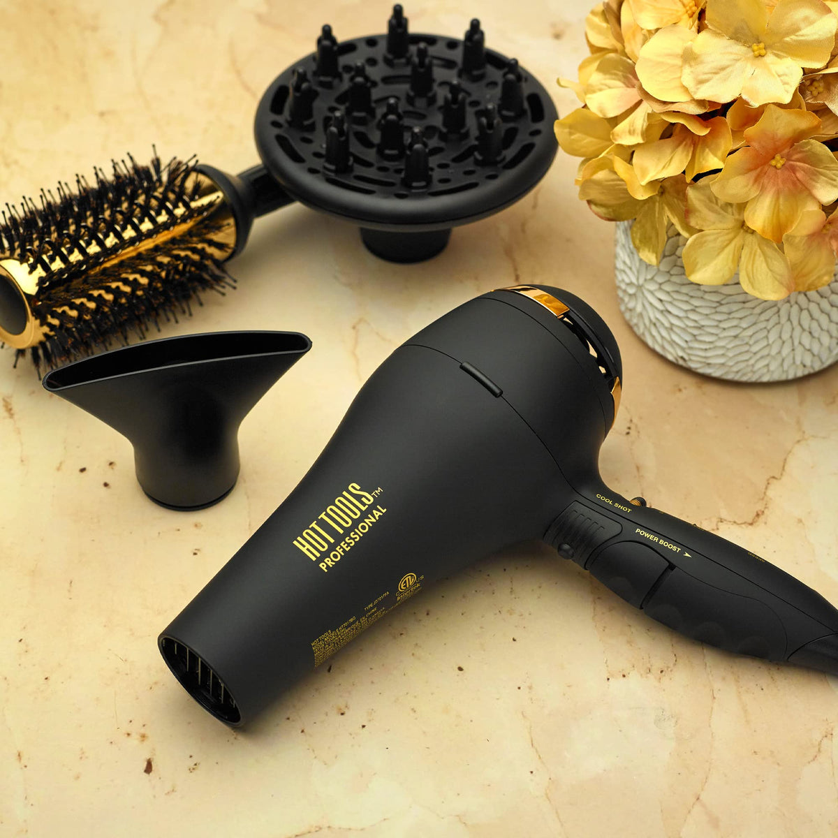 Hot Tools Pro Artist Black Gold lightweight design in hand for comfortable daily blow-drying.