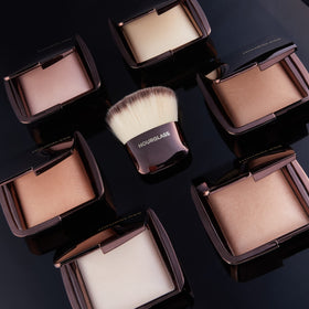 Hourglass Dim Light powder application demonstrating light diffusion for flattering skin.