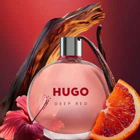 Hugo Boss Deep Red bottle cap and glass gleam in soft light, signaling wearable luxury