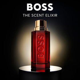 Hugo Boss The Scent Elixir bottle on red glass captures premium packaging