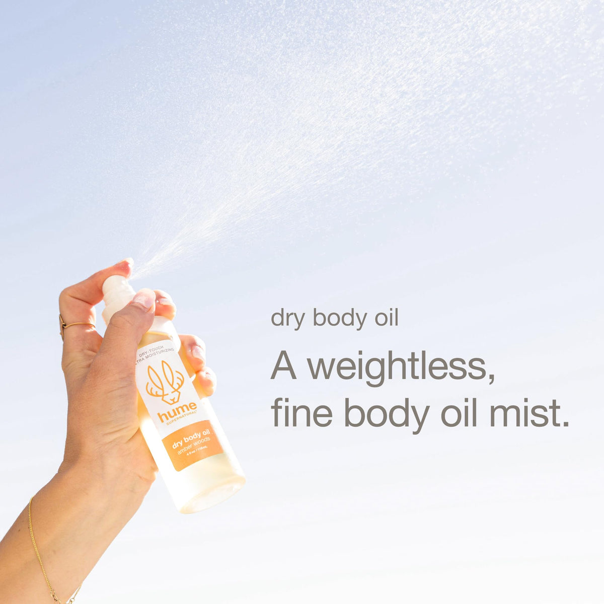 Hume Supernatural dry body oil spray texture shows non-greasy finish after massage.