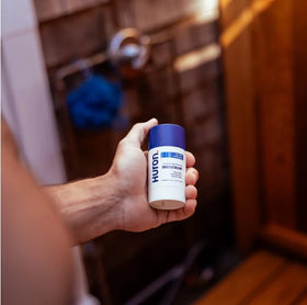 Huron deodorant in a daily-use scene suggests an effortless morning routine.