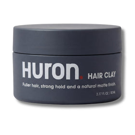 Huron Hair Clay jar close-up shows premium matte finish for natural texture.