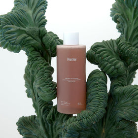 Premium bottle on bathroom counter suggesting a ritual skincare moment.