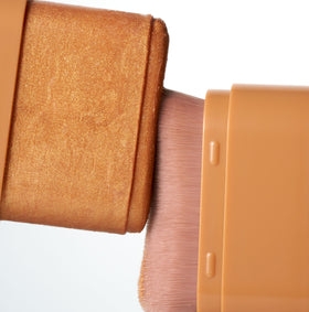 Iconic London Glow All Over Melting Balm Stick applied to shoulders for a lit-from-within shimmer.