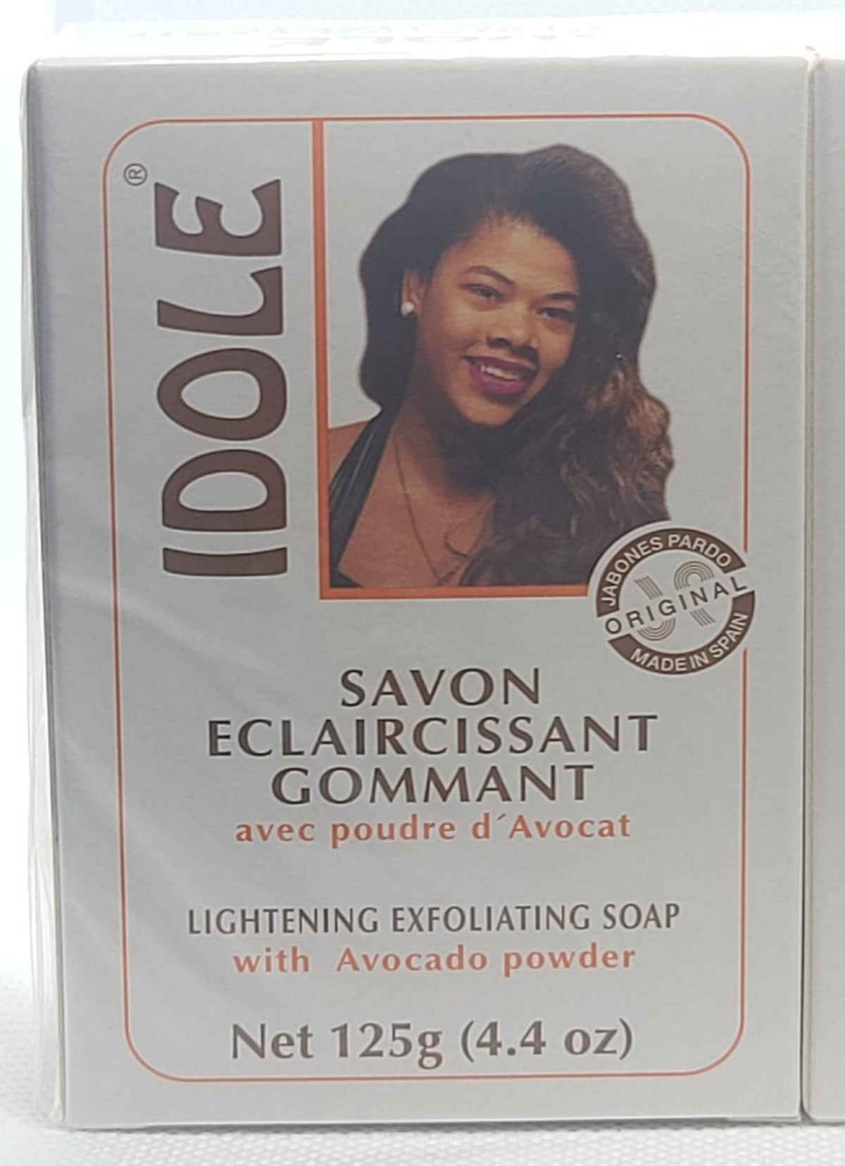 Close-up of Idole exfoliating soap bar reveals avocado seed powder texture for smoothing.