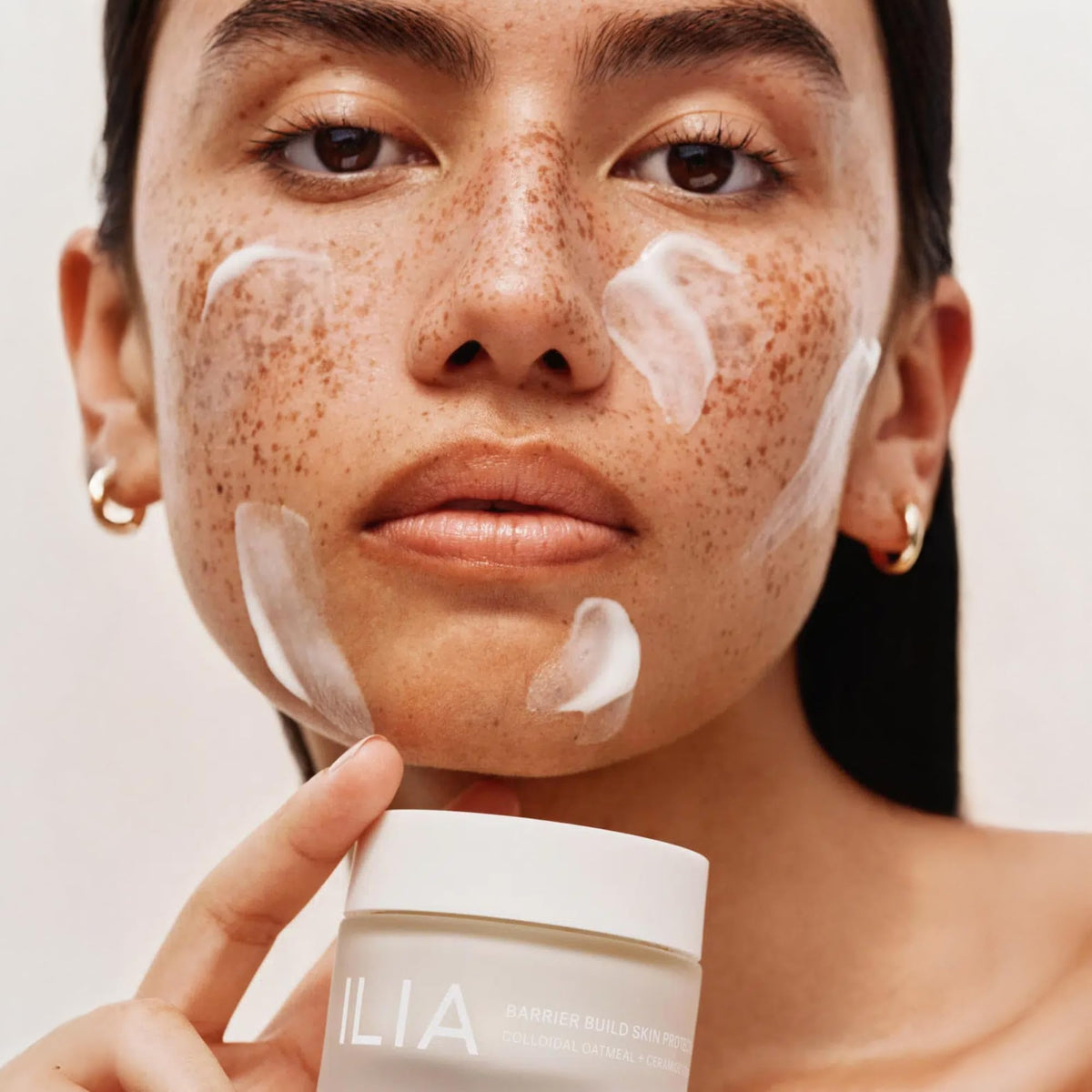 Creamy ILIA Barrier Build texture on skin with visible hydration glow