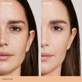 Close-up of ILIA Skin Rewind Complexion Stick on skin for smooth texture.