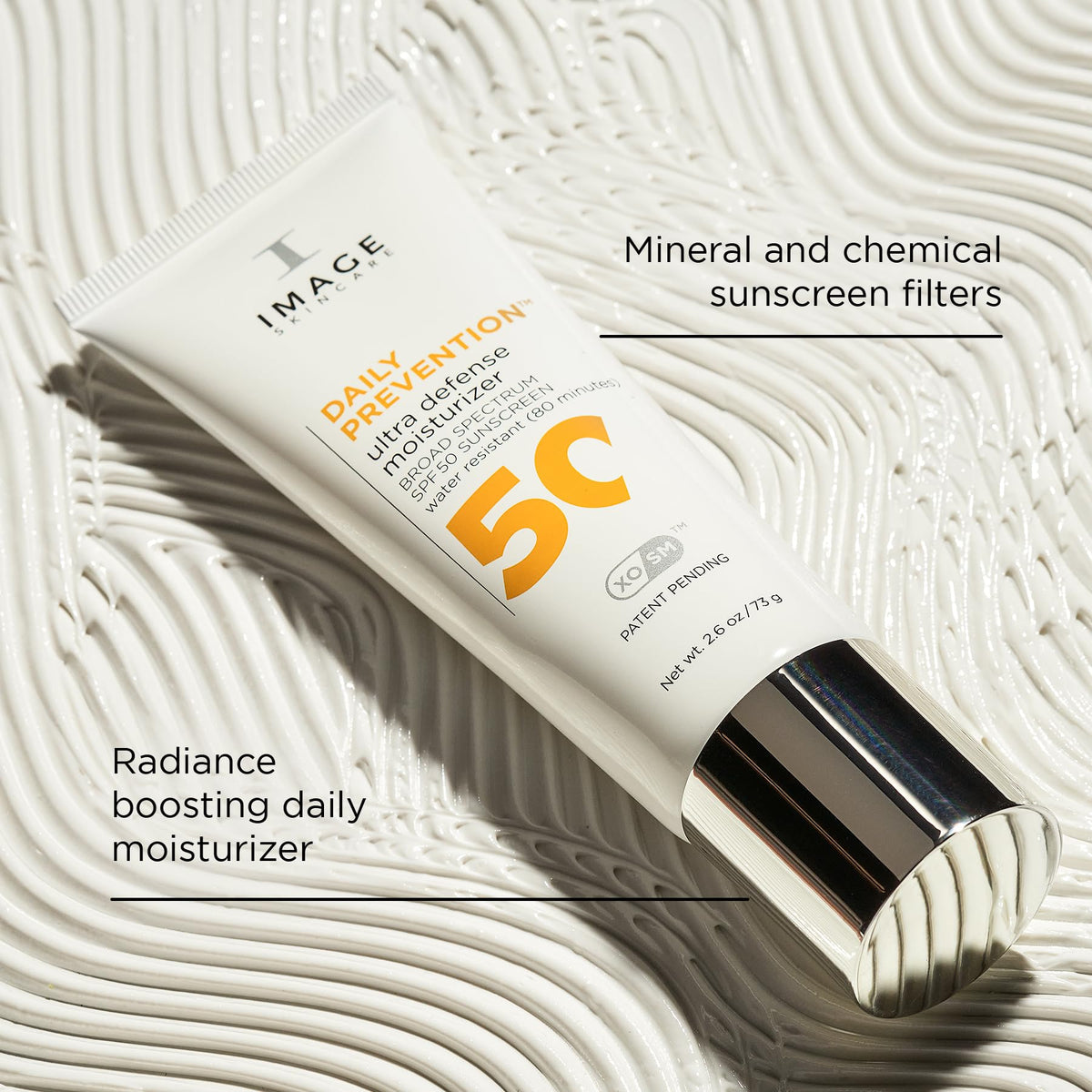 Hands applying IMAGE Skincare DAILY PREVENTION SPF 50 on the skin for even coverage.