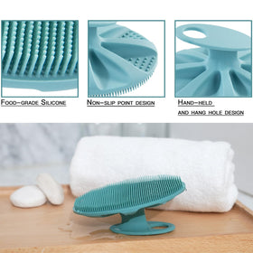 INNERNEED silicone shower scrubber handle close-up showing secure grip.