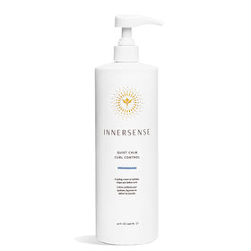 INNERSENSE Quiet Calm Curl Control bottle on counter showing defined curls.