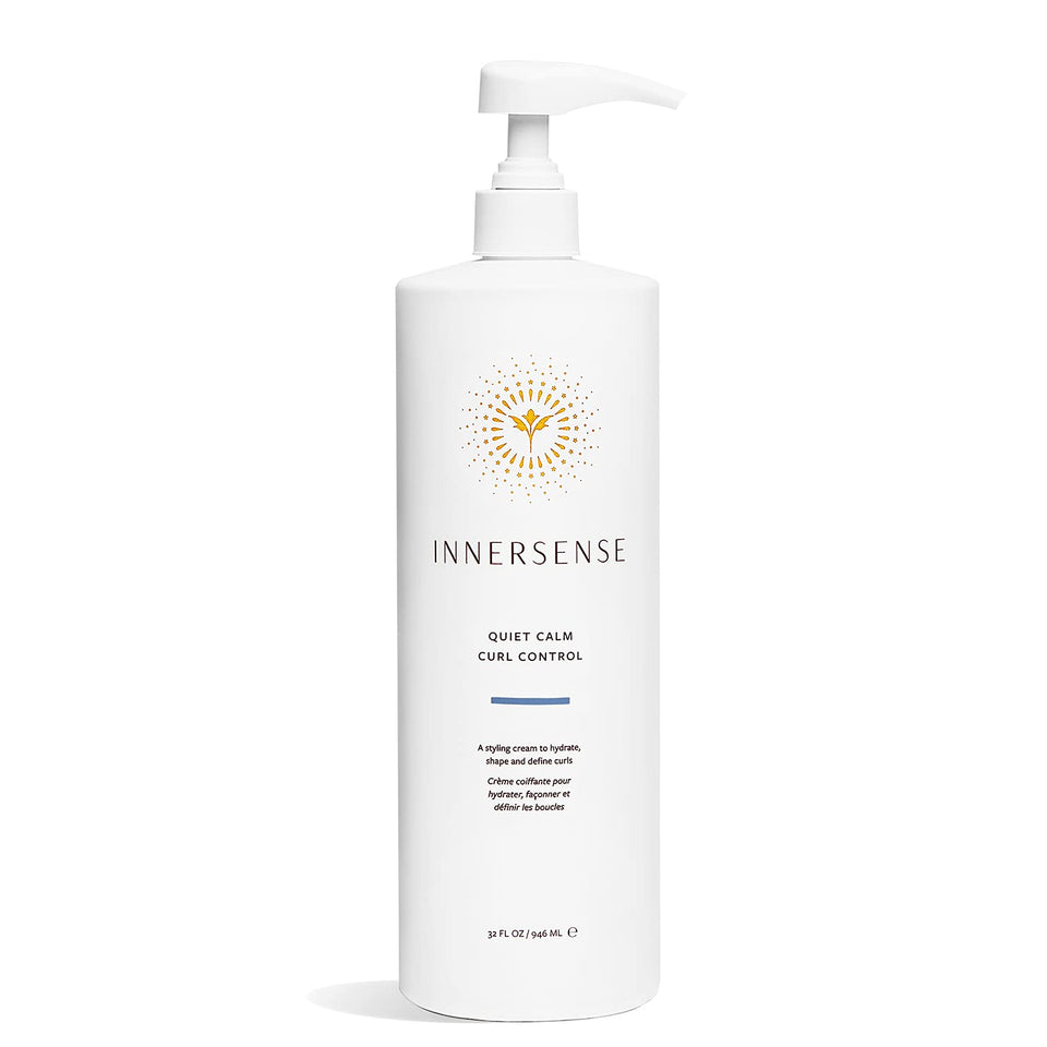 INNERSENSE Quiet Calm Curl Control bottle on counter showing defined curls.