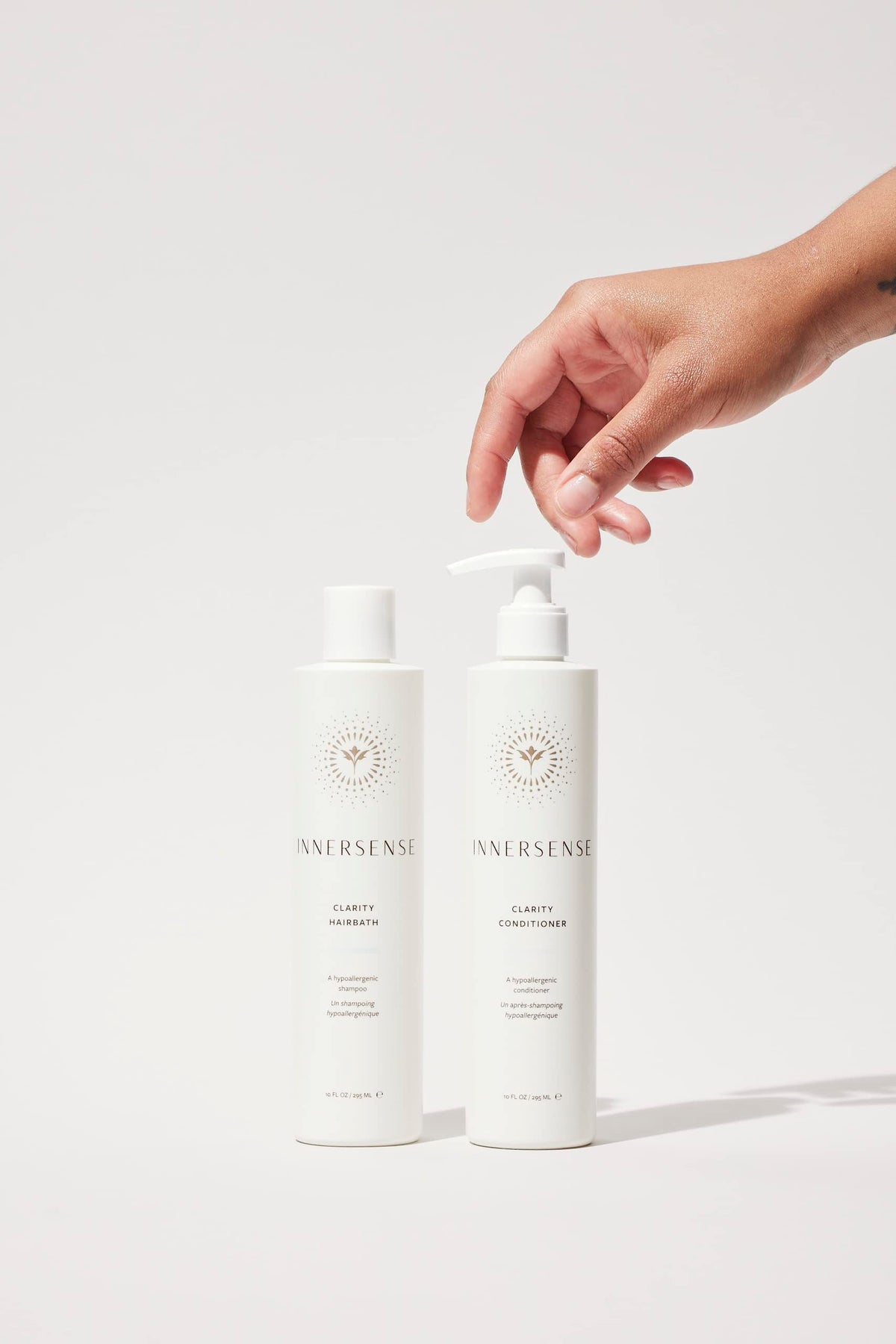 INNERSENSE conditioner bottle close-up highlighting deep moisturizing for soft hair.