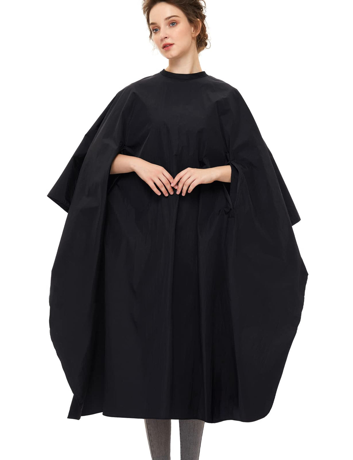 Izzycka barber cape with armholes, closed neck for secure, comfortable wear during haircuts.