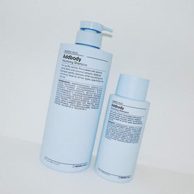 J Beverly Hills Addbody label detail on blue bottle implying salon quality care.
