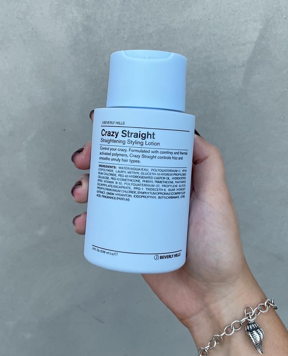Applying J Beverly Hills Blue Crazy Straight lotion to damp hair