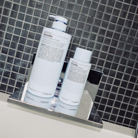 Hand applying shampoo to wet hair, showcasing daily moisturizing formula.