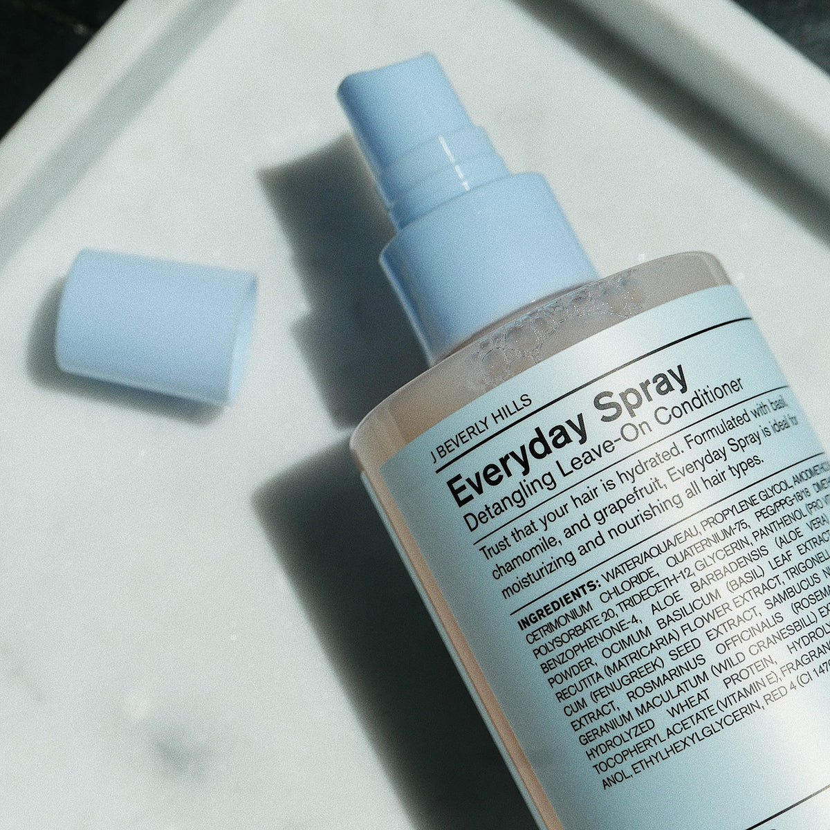 J Beverly Hills Blue Everyday spray nozzle shown for precise application.