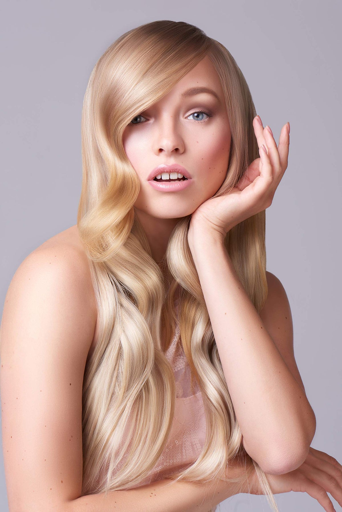 Brand logo on the bottle signals professional-quality hair care.