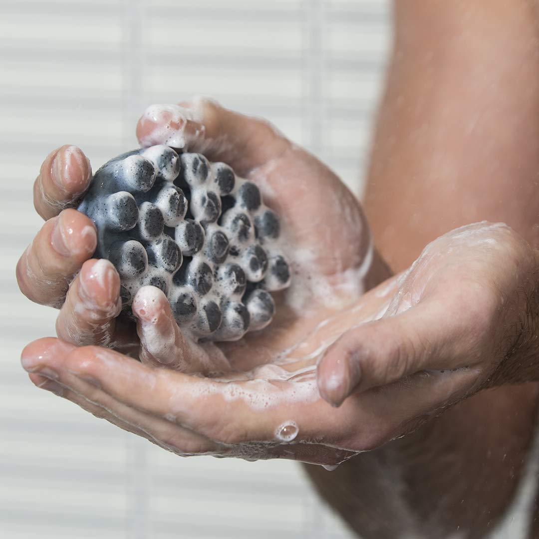 Jack Black Charcoal Body Bar lathers with exfoliating jojoba beads for smoother skin