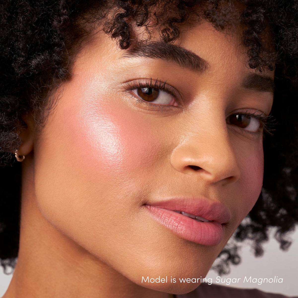 Jane Iredale ColorLuxe Liquid Blush layered over foundation for depth.