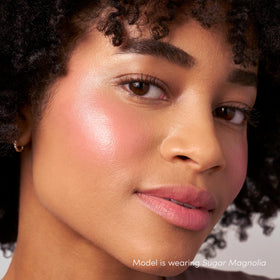 Jane Iredale ColorLuxe Liquid Blush layered over foundation for depth.