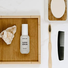 Hand applying JAXON LANE SUPER SERUM to demonstrate quick absorption