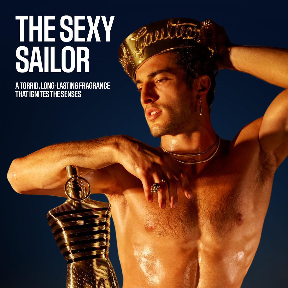 Jean Paul Gaultier Le Male Elixir travel spray tin packaging close-up for collector appeal.