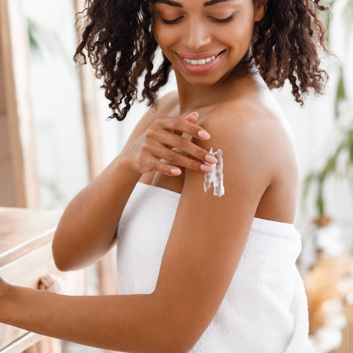 Hands applying Jergens Shea Butter Lotion with a non-greasy finish.