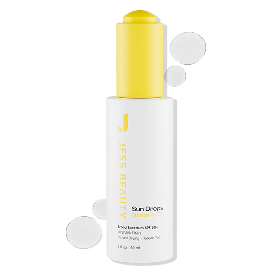 Jess Beauty Face Sunscreen Sun Drops SPF 50 bottle on vanity provides lightweight protection.
