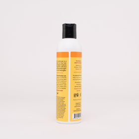 Product being worked through wet hair to reduce breakage with Aloeba.