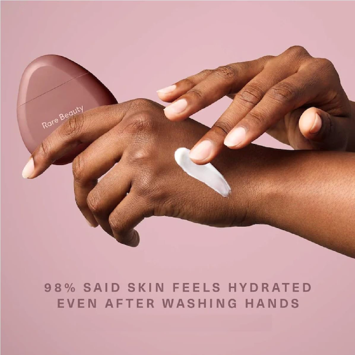 Gently applying JIGME CALA Rare hand cream on hands for quick absorption.