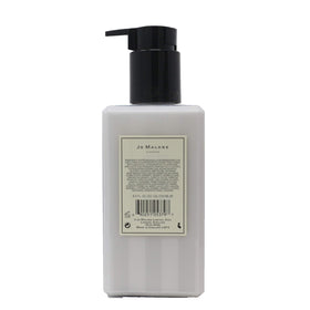 Jo Malone Peony & Blush Suede lotion in use delivering silky, fast-absorbing hydration.