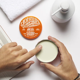 Johnny's Chop Shop Wild Cat Hair Clay signature citrus-cedar-patchouli scent for refreshing salon feel