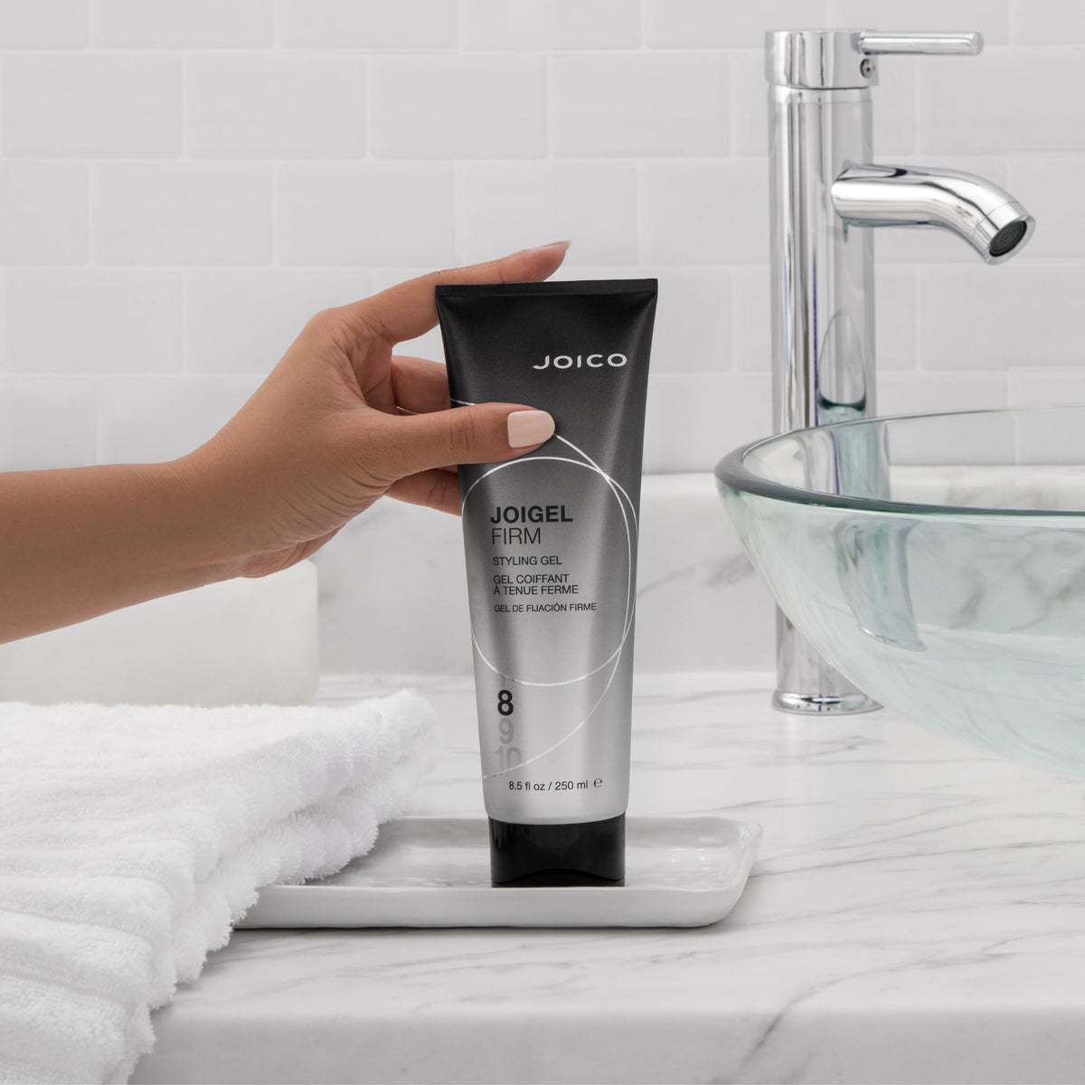 Second JoiGel Firm bottle closeup emphasizing heat protection for smooth results.