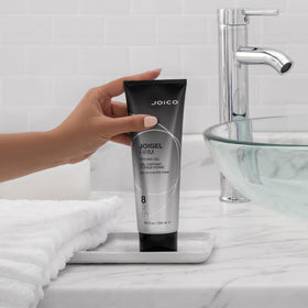 Second JoiGel Firm bottle closeup emphasizing heat protection for smooth results.