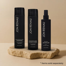 Jon Renau Argan Smooth Conditioner bottle on vanity highlighting color-safe hydration.