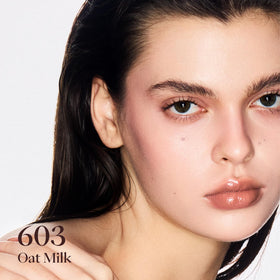 Joocyee Glazed Gloss 603 Oat Milk swatch shows buildable sheer color for natural enhancement.