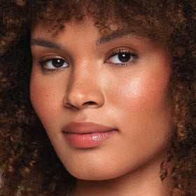 Jouer Essential Vegan Lip Enhancer rose-application demonstrates glossy fullness.
