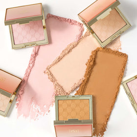 Jouer Soft Focus Brightening Powder swatch displaying peach-tinted radiance on skin
