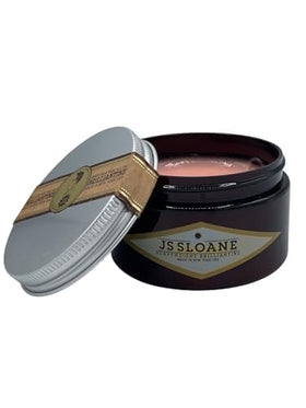 JS Sloane applying pomade to hair for flexible, long-lasting styling.