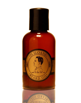 JS Sloane beard oil bottle on table illustrating conditioning formula for beard and skin
