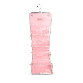Juicy Couture pink makeup bag shown on hanging hook for quick access on the go.