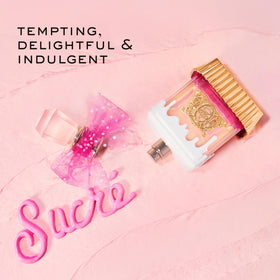 Display of Juicy Couture travel spray pens arranged for easy access