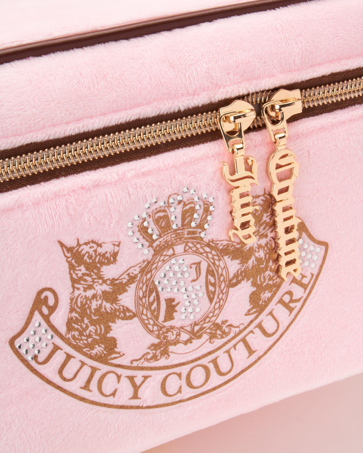 Juicy Couture pink bag interior with lined compartments keeps cosmetics organized on the go